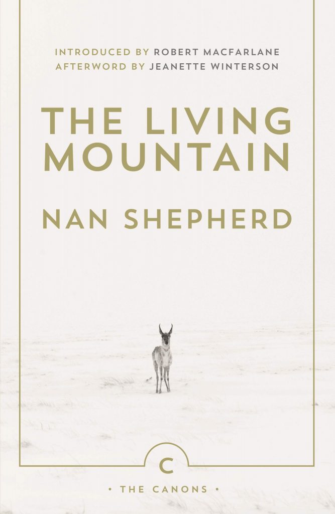 Cover image of The Living Mountain by Nan Shepherd. The cover features a deer facing the camera against a background of snow.